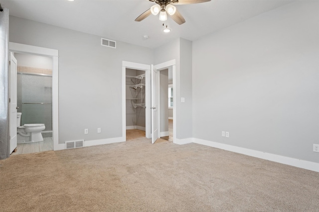 2421 Half Hitch Dr, Missoula, MT 59808 - unfurnished bedroom featuring baseboards, carpet flooring, visible vents, and a walk in closet