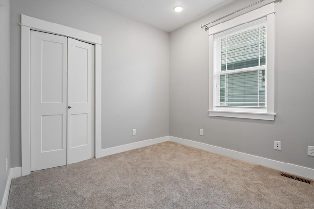 2421 Half Hitch Dr, Missoula, MT 59808 - unfurnished bedroom with carpet flooring, baseboards, a closet, and visible vents