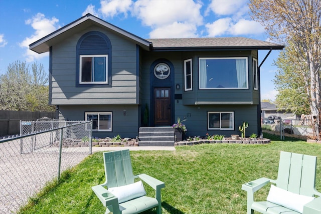 raised ranch featuring a front yard and fence