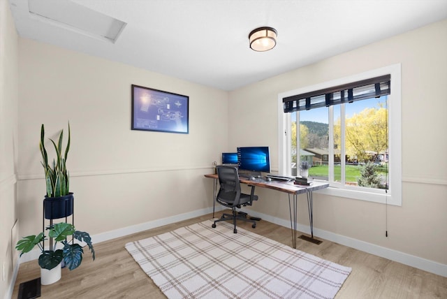 office area with attic access, visible vents, wood finished floors, and baseboards
