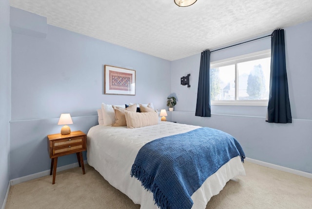 carpeted bedroom with baseboards and a textured ceiling