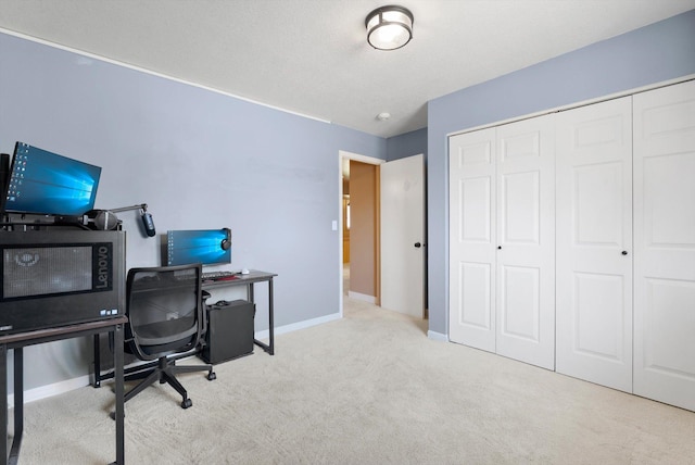 carpeted home office featuring baseboards