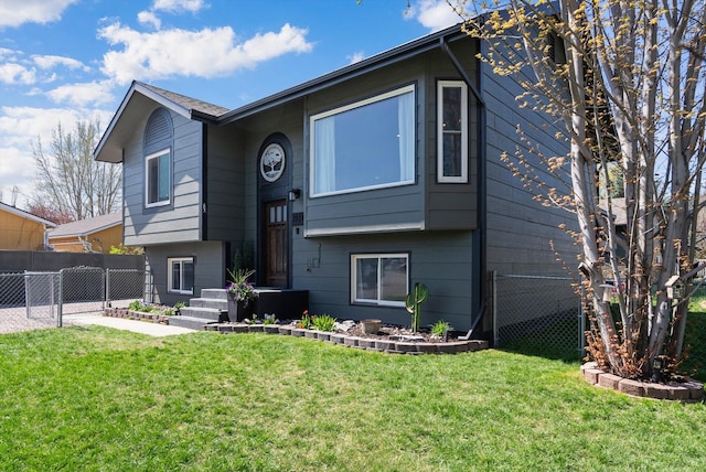 bi-level home with fence and a front yard
