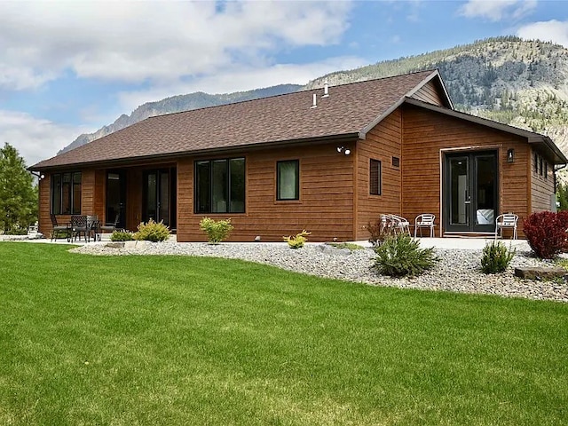 2 Mahonia Ct, Plains, MT 59859 - back of property with a mountain view, a yard, roof with shingles, and a patio area