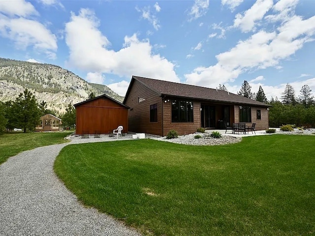 2 Mahonia Ct, Plains, MT 59859 - view of front facade with aphalt driveway, a mountain view, an attached garage, and stone siding
