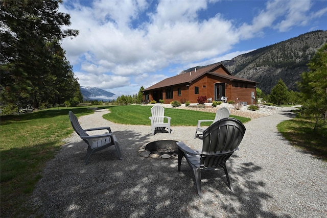 2 Mahonia Ct, Plains, MT 59859 - view of home's community with a yard, a fire pit, and a mountain view