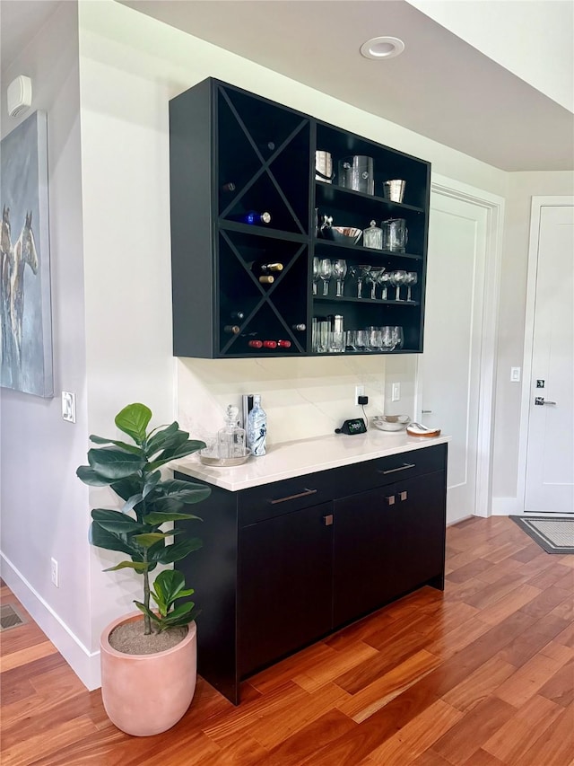 2 Mahonia Ct, Plains, MT 59859 - bar featuring baseboards, recessed lighting, a bar, and light wood-type flooring
