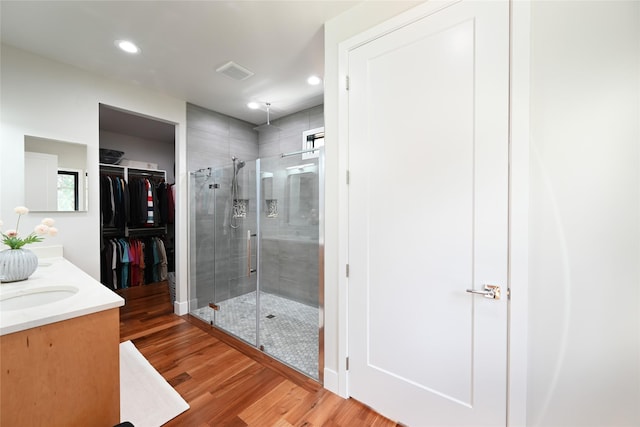2 Mahonia Ct, Plains, MT 59859 - full bathroom with wood finished floors, visible vents, recessed lighting, a shower stall, and a walk in closet