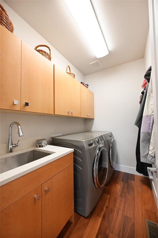 2 Mahonia Ct, Plains, MT 59859 - laundry area featuring dark wood-style flooring, a sink, separate washer and dryer, and cabinet space