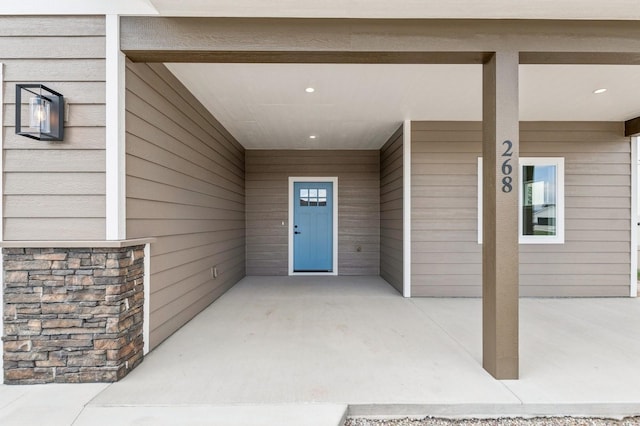entrance to property featuring stone siding