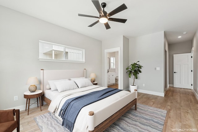 268 Landing Ln, Kalispell, MT 59901 - bedroom featuring light wood-style flooring, baseboards, ensuite bath, and a ceiling fan