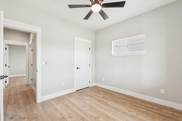 unfurnished bedroom with baseboards, ceiling fan, and light wood-type flooring