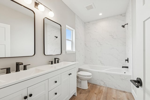 268 Landing Ln, Kalispell, MT 59901 - full bath with toilet, a combined bath / shower with marble appearance, wood finished floors, double vanity, and recessed lighting