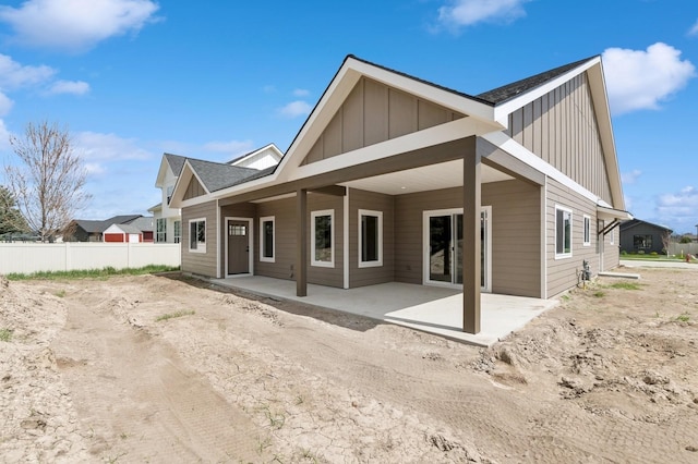 back of property featuring a patio area, fence, and board and batten siding