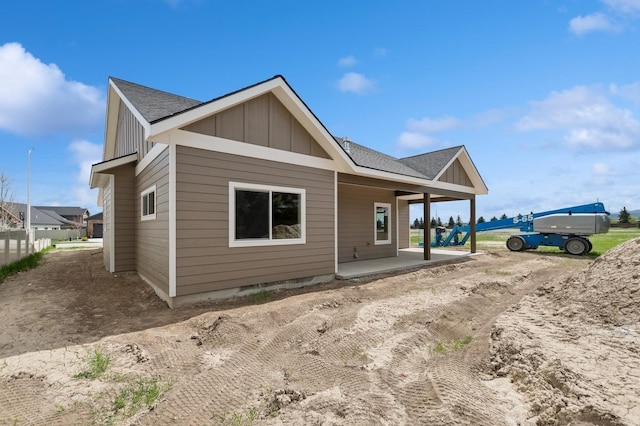 back of property featuring covered porch, board and batten siding, and a shingled roof