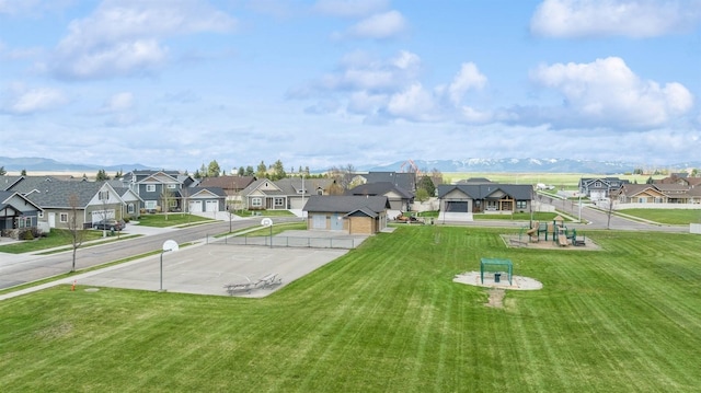 view of home's community featuring a lawn, a mountain view, and a residential view