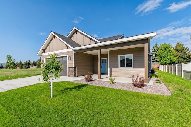 268 Landing Ln, Kalispell, MT 59901 - view of front of house featuring board and batten siding, an attached garage, concrete driveway, stone siding, and a porch