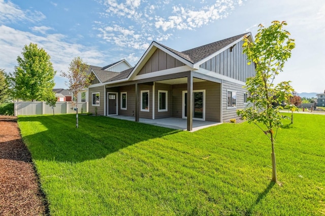 268 Landing Ln, Kalispell, MT 59901 - rear view of house with board and batten siding, a patio, and roof with shingles