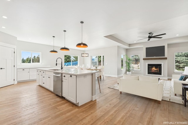 268 Landing Ln, Kalispell, MT 59901 - kitchen with a sink, stainless steel dishwasher, open floor plan, light wood-style floors, and recessed lighting