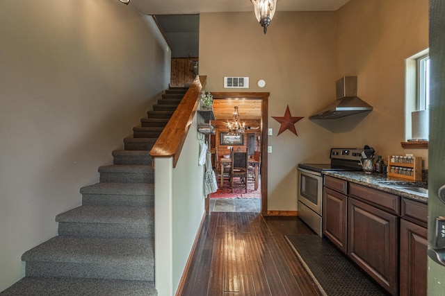 420 Deer Creek Rd, Lakeside, MT 59922 - stairway with hardwood / wood-style floors and a chandelier