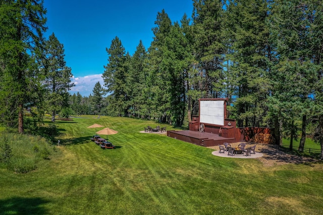 420 Deer Creek Rd, Lakeside, MT 59922 - view of grassy yard featuring an outdoor fire pit and a patio area