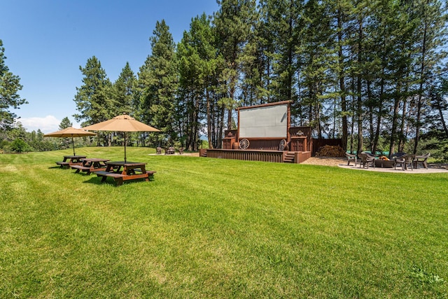 420 Deer Creek Rd, Lakeside, MT 59922 - view of green lawn featuring a deck and a fire pit