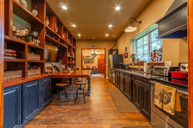 420 Deer Creek Rd, Lakeside, MT 59922 - kitchen featuring appliances with stainless steel finishes, dark wood-style flooring, open shelves, recessed lighting, and dark stone countertops