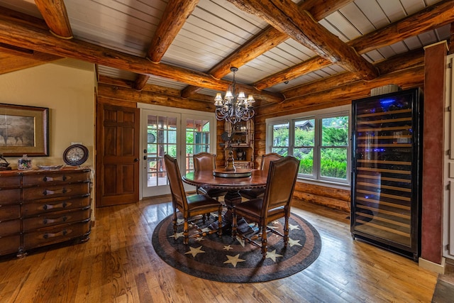 420 Deer Creek Rd, Lakeside, MT 59922 - dining area with wine cooler, wood-type flooring, a chandelier, a wooden ceiling with exposed beams, and french doors