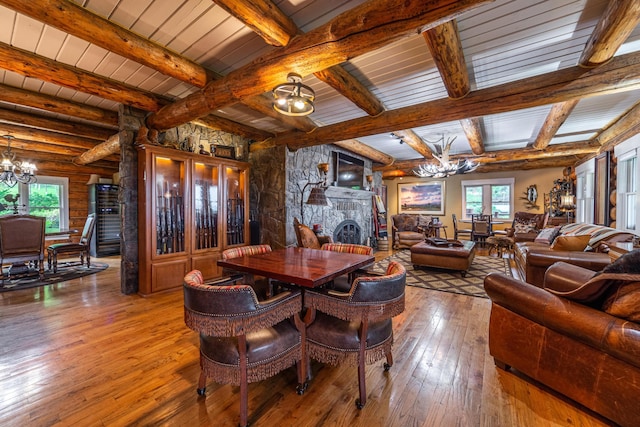 420 Deer Creek Rd, Lakeside, MT 59922 - dining room featuring a chandelier, wood-type flooring, beam ceiling, and a fireplace