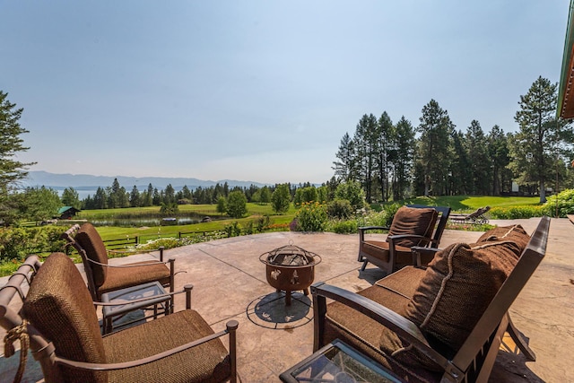 420 Deer Creek Rd, Lakeside, MT 59922 - view of patio with a fire pit and a water and mountain view