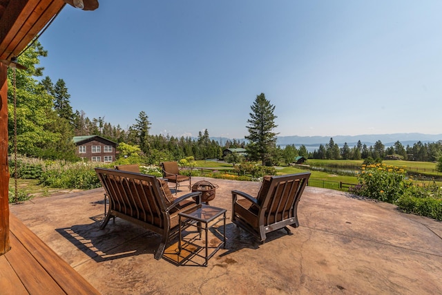 420 Deer Creek Rd, Lakeside, MT 59922 - view of patio with an outdoor fire pit and a mountain view