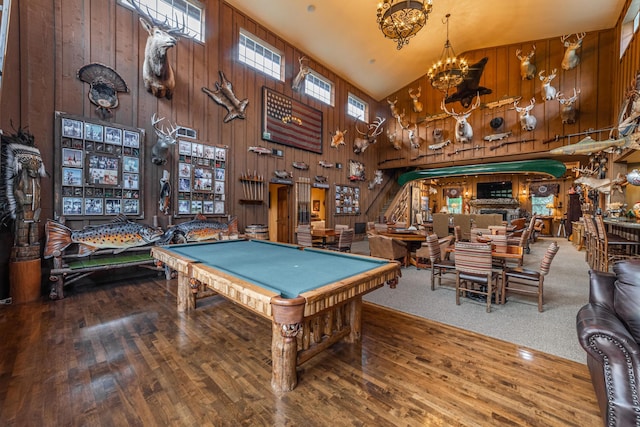 420 Deer Creek Rd, Lakeside, MT 59922 - game room featuring billiards table, wood walls, a chandelier, wood-type flooring, and high vaulted ceiling