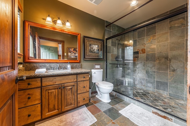 420 Deer Creek Rd, Lakeside, MT 59922 - full bath featuring a tile shower, vanity, and stone finish floors