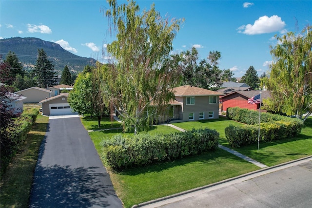 1611 Peosta Ave, Helena, MT 59601 - view of home's community with a yard, a garage, and a mountain view