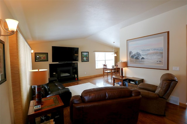 1611 Peosta Ave, Helena, MT 59601 - living area with lofted ceiling, baseboards, visible vents, and wood finished floors