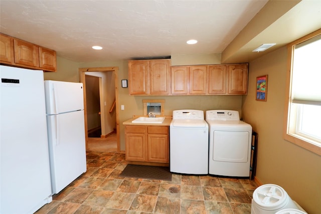 1611 Peosta Ave, Helena, MT 59601 - clothes washing area with a sink, cabinet space, recessed lighting, washing machine and dryer, and baseboards