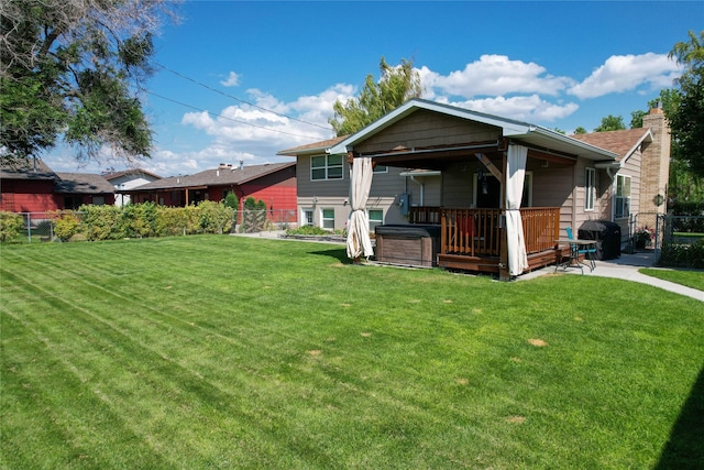 1611 Peosta Ave, Helena, MT 59601 - rear view of property featuring a yard, a hot tub, and a fenced backyard