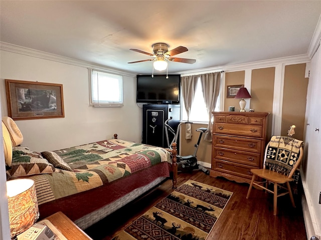 bedroom featuring ornamental molding, a ceiling fan, and dark wood finished floors