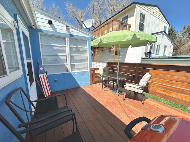 deck with outdoor dining area