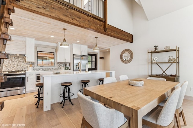 dining area featuring light wood-style flooring and recessed lighting