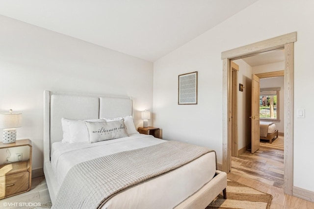 bedroom with light wood finished floors and baseboards