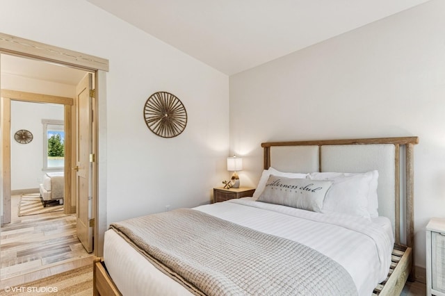 bedroom with vaulted ceiling and baseboards