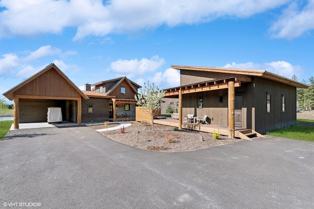 property under construction featuring a porch and a detached garage