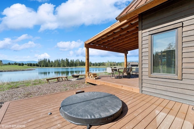 deck featuring a water view and outdoor dining space