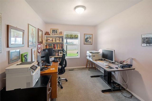 carpeted office space with baseboards