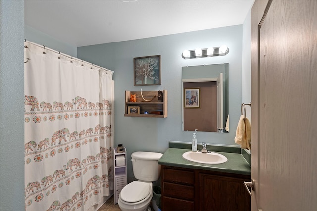 full bathroom with toilet, vanity, and curtained shower