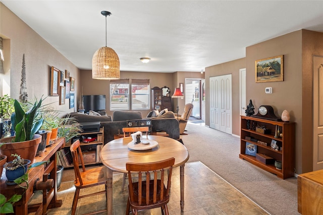 dining space featuring light carpet