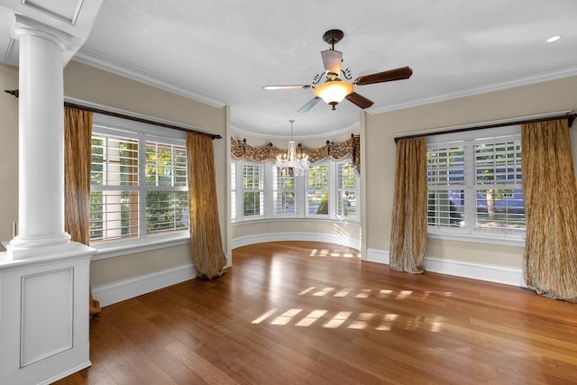 305 Columbia Ave, Whitefish, MT 59937 - unfurnished dining area with decorative columns, a ceiling fan, wood finished floors, crown molding, and a chandelier