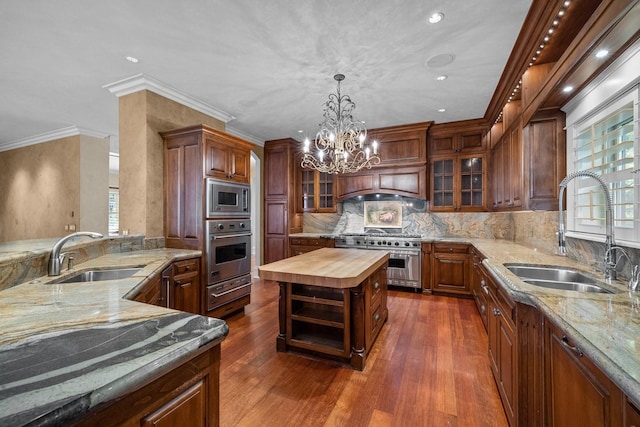 305 Columbia Ave, Whitefish, MT 59937 - kitchen with stainless steel appliances, wooden counters, a chandelier, a warming drawer, and decorative light fixtures