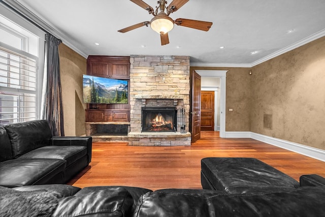 305 Columbia Ave, Whitefish, MT 59937 - living room with wood finished floors, ceiling fan, ornamental molding, a stone fireplace, and recessed lighting